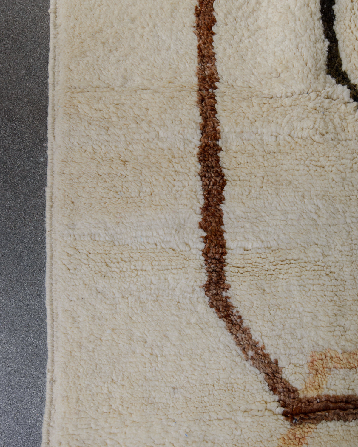 Detail of wool rug showing some discolouration.